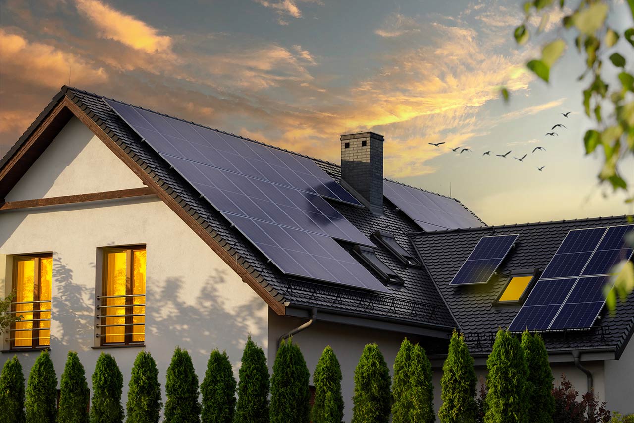 Night view of a beautiful white house with solar panels